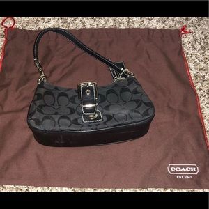 Small black signature coach bag.